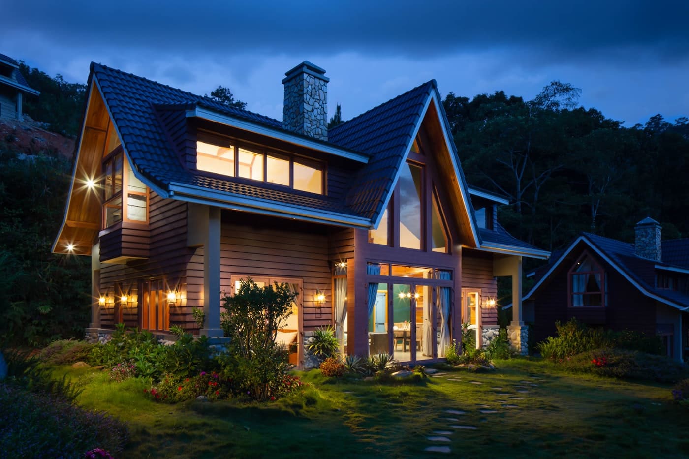 A warm, well-kept home lit up at dusk